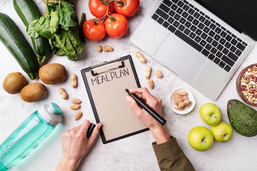 Illustration of a meal planning workspace with notebook and fresh ingredients